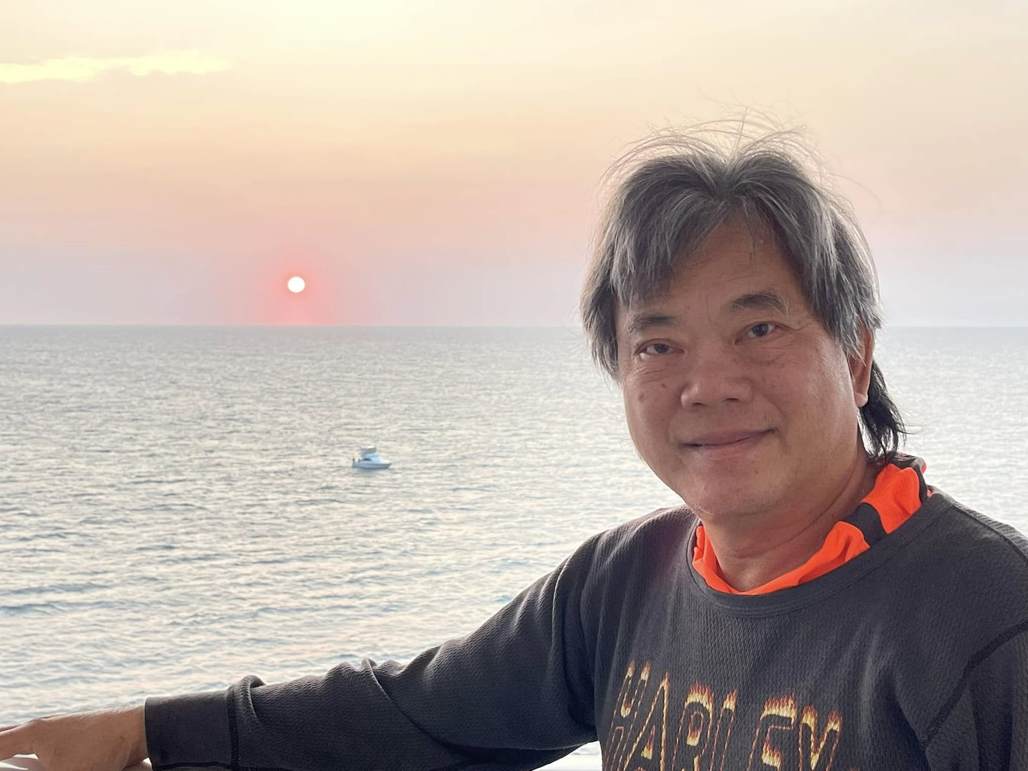 Sam by the sea at sunset during his recovery