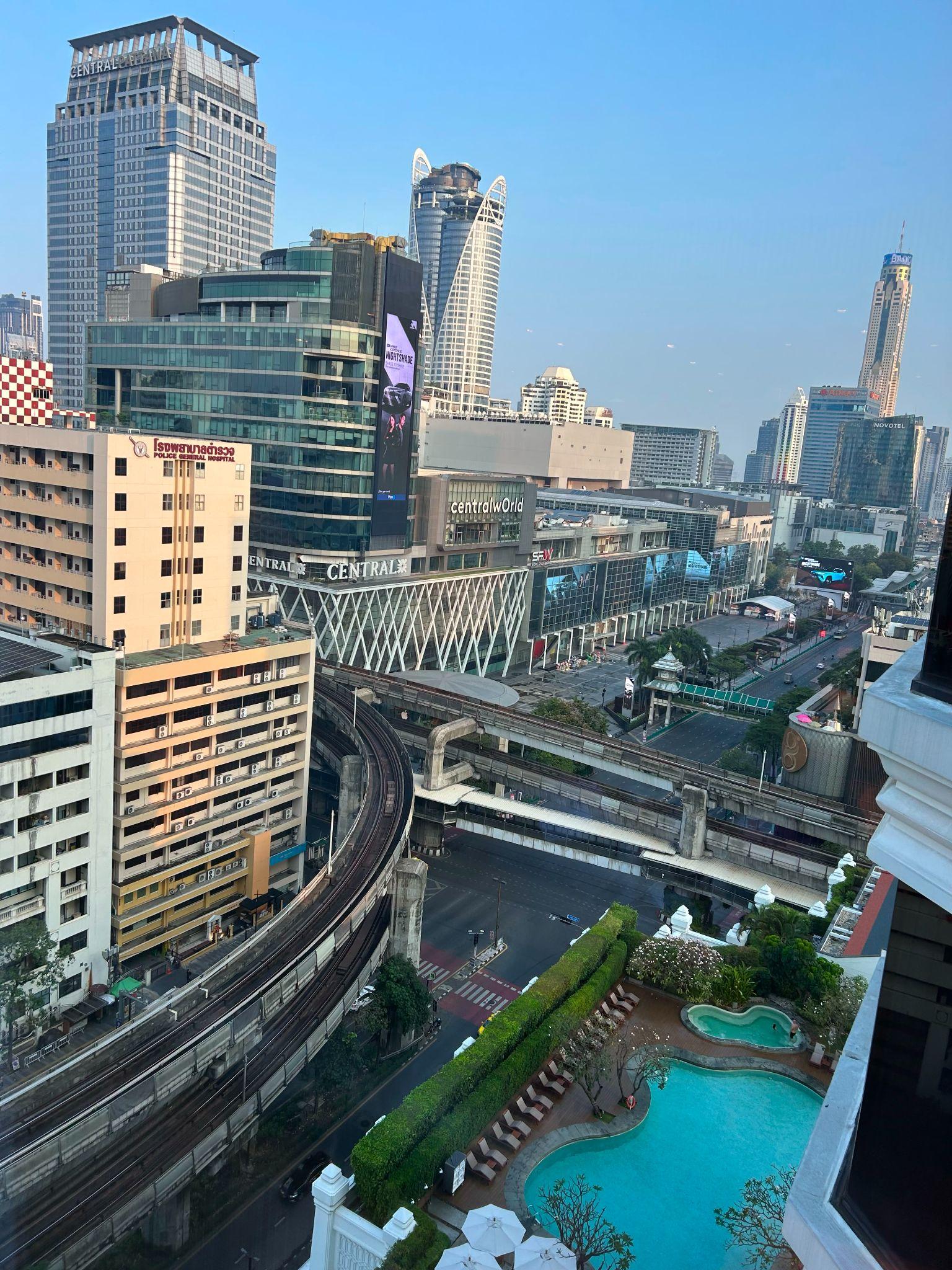 Early morning view of the Bangkok skyline and CentralwOrld from a high-floor hotel room.