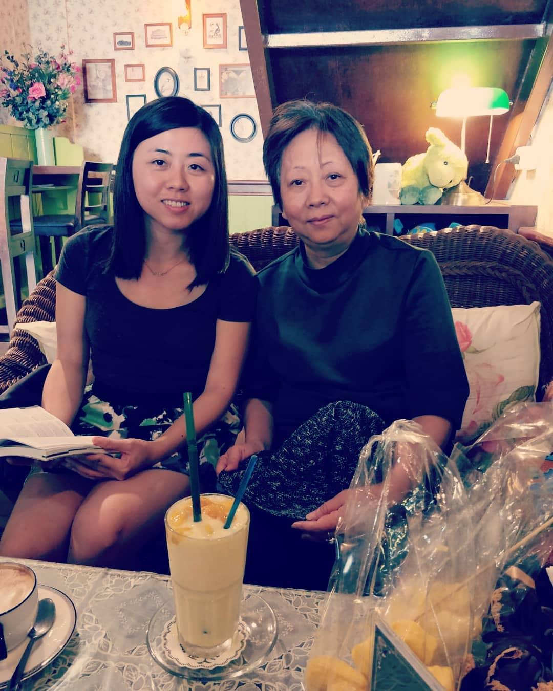 Cherry and her mom sharing a drink at a cafe in Phuket.