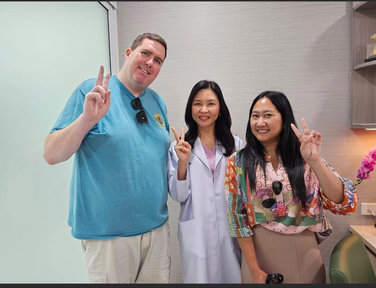 Brian and his wife with their LASIK surgeon at the clinic after the procedure.