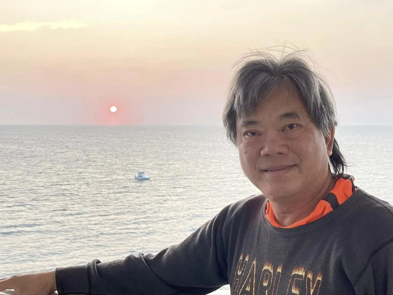 Sam M. by the water at sunset in Thailand